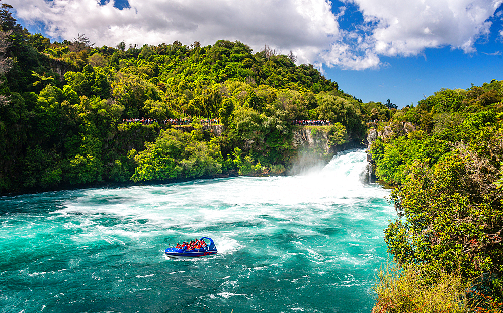 Huka falls near lake Taupo. Turquoise water white water jet boat rafting at the waterfall in Waikato River. New Zealand.