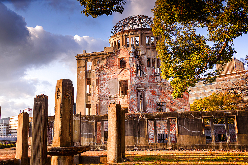 Historic Hiroshima Peace Memorial Dome at Sunset with Golden Light and Trees in Hiroshima Peace Memorial Park, Japan