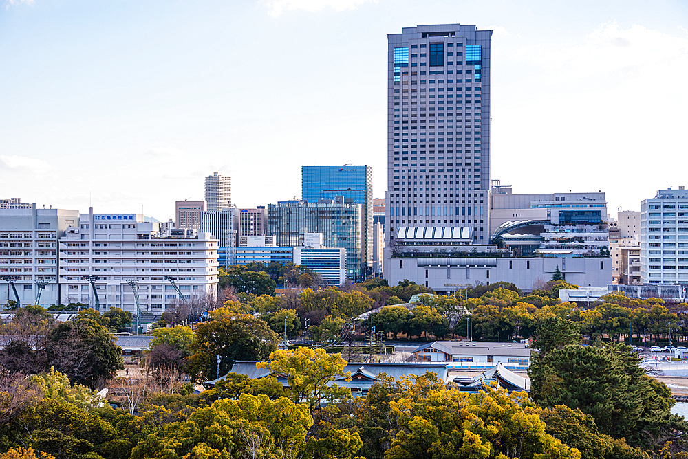 Urban Skyline of Hiroshima City with Office Buildings and Tree-Lined Rivers at Sunset, Viewed from Hiroshima Castle main tower Japan