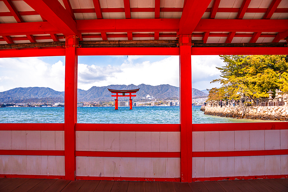 Framed View of the Itsukushima Shrine Torii Gate Through the Red Architecture of the Shrine on Miyajima Island, Japan