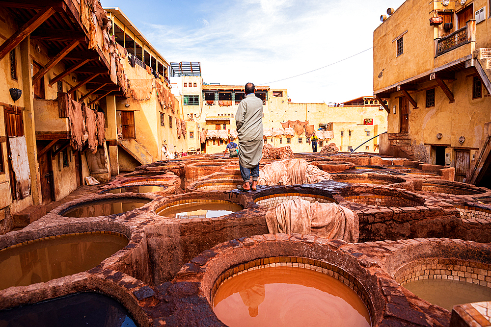 Worker Standing Among Traditional Leather Tanning Pits at the Famous Chouara Tannery in Fes, Morocco