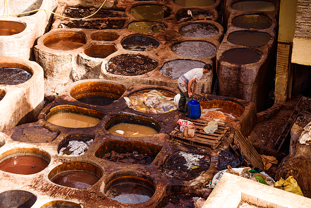 Worker Stirring Dye Mixtures in Brown and Black Leather Vats at Chouara Tannery, Fes, Morocco