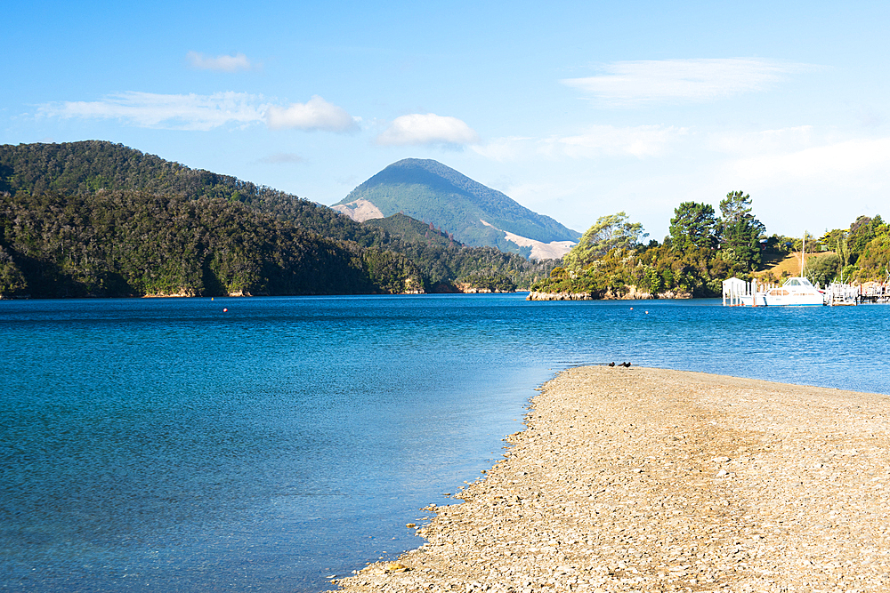 Clear Blue Waters Lapping Against Narrow Beach with Boats and Hills in Queen Charlotte Sound, Marlborough Sounds, New Zealand