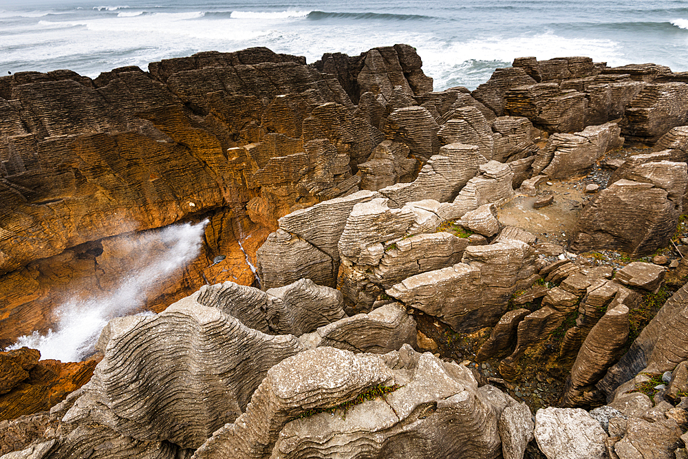 Dramatic Sea Burst from Blowhole in Layered Limestone Formations at Pancake Rocks, West Coast, New Zealand