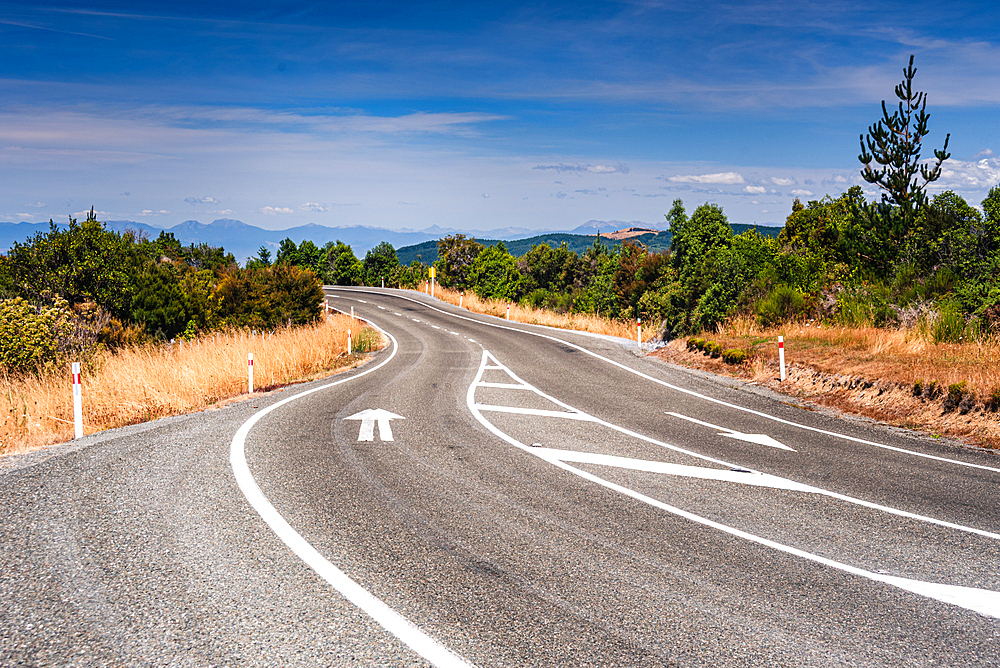 Sweeping Bend on Mountain Road Overlooking Valley and Peaks, South Island Landscape, New Zealand