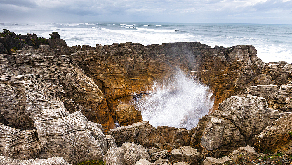 Seawater Blasting Through Blowhole in Sculpted Rock at Pancake Rocks, Punakaiki, New Zealand