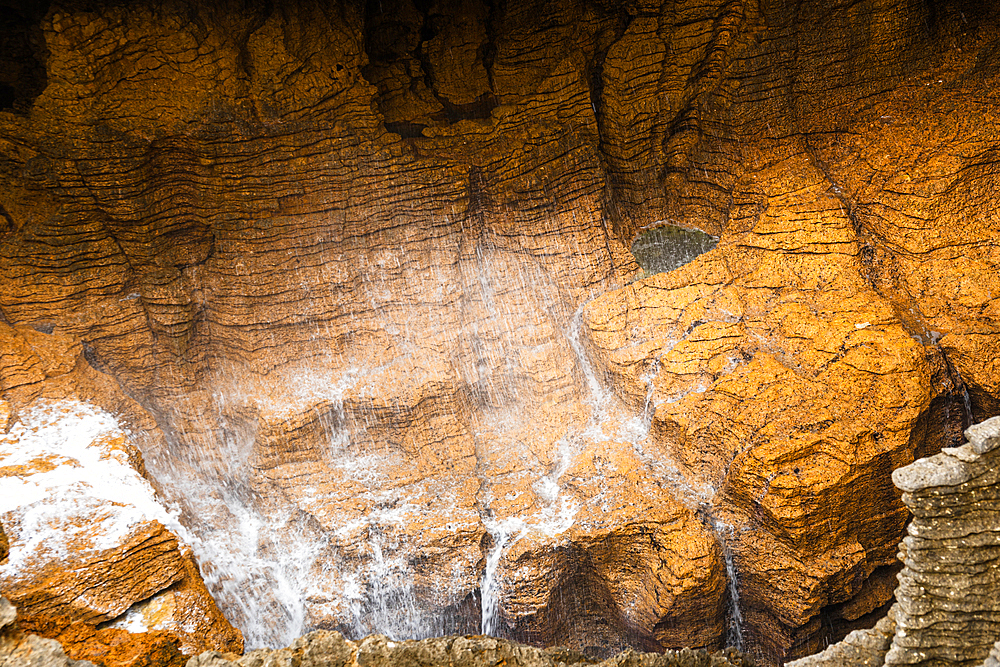 Golden Light on Eroded Honeycomb Limestone Cliffs at Pancake Rocks, West Coast, New Zealand