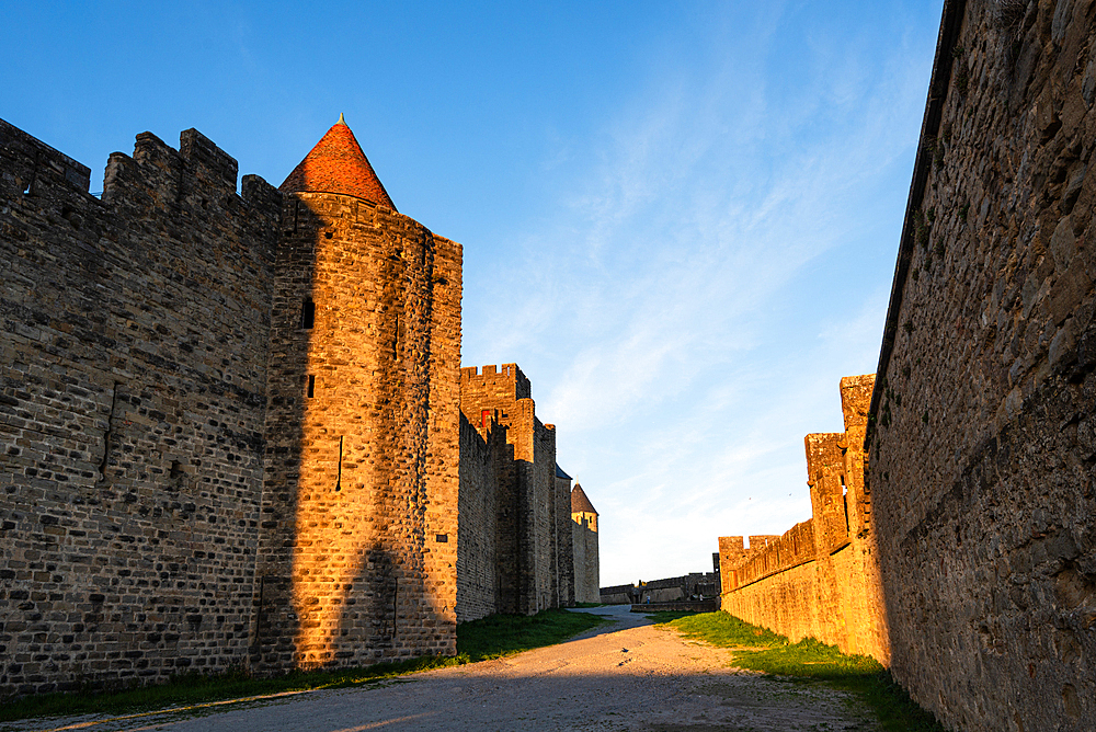 Rich Golden Light Highlighting the Texture of the Stone Walls and Battlements in the Fortified City of Carcassonne