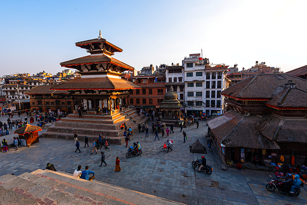 Elevated view of Durbar Square in Kathmandu with Nyatapola-style pagoda temple and surrounding urban life during golden hour
