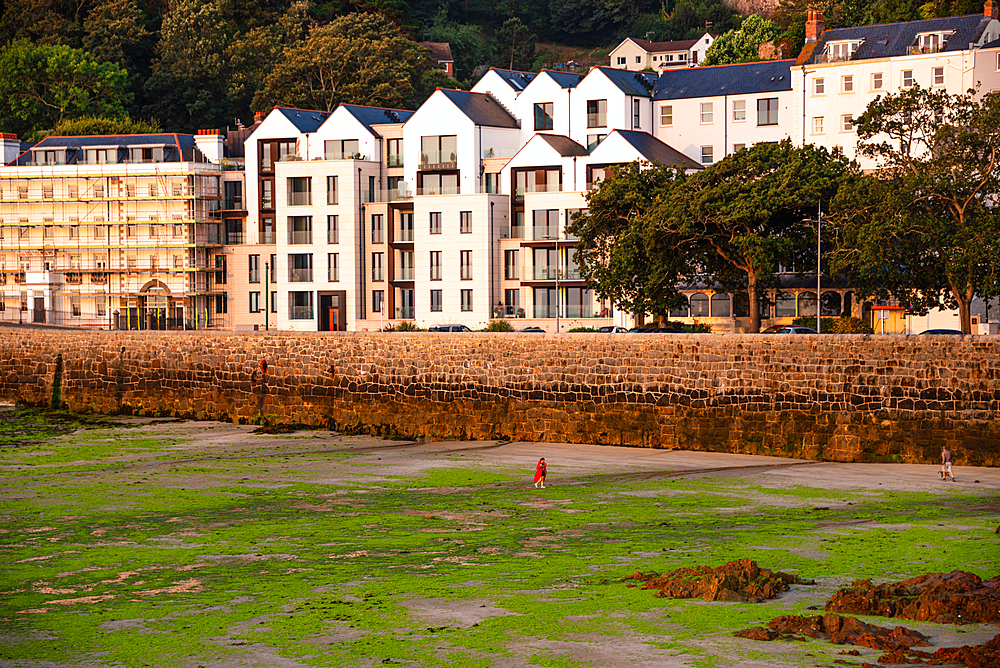 Historic waterfront houses overlooking the harbour at low tide in St Peter Port, Guernsey, Channel Islands.