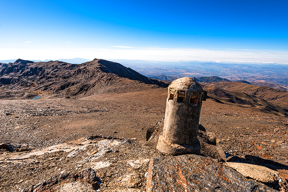 Remains of a crumbling military watchtower in the high Sierra Nevada, Andalusia, Spain. Historic architecture against the barren alpine landscape.