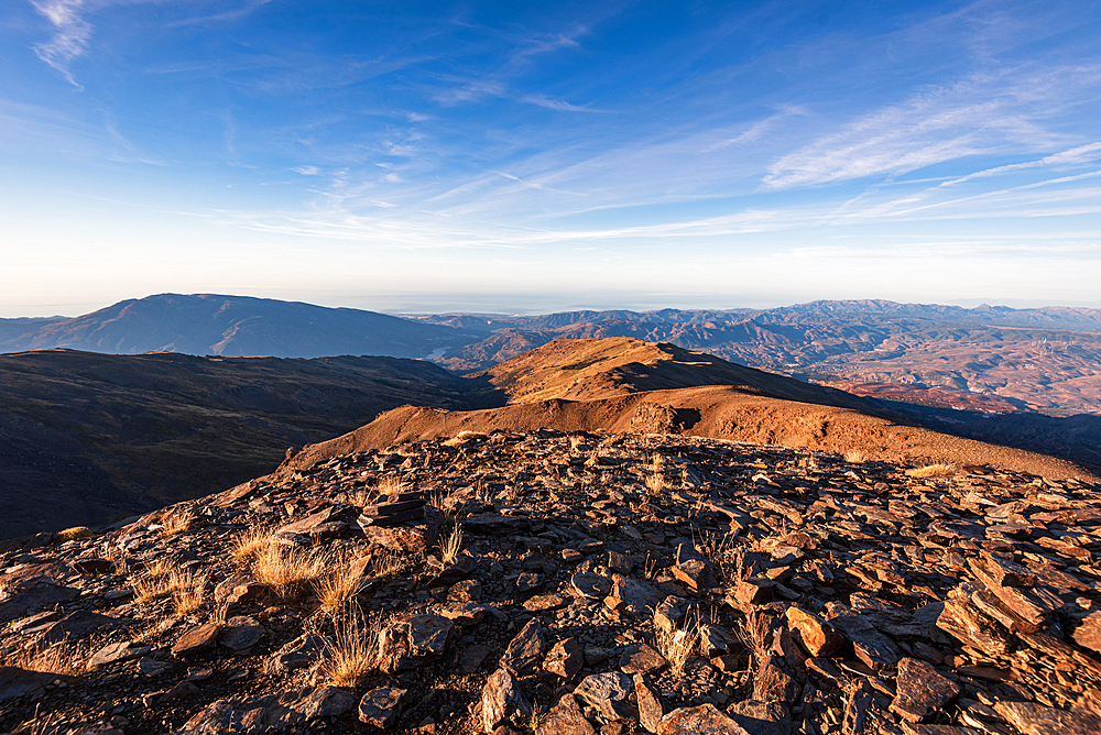 Wide summit ridge with panoramic mountain views from Pico del Caballo , Sierra Nevada, Andalusia, Spain.