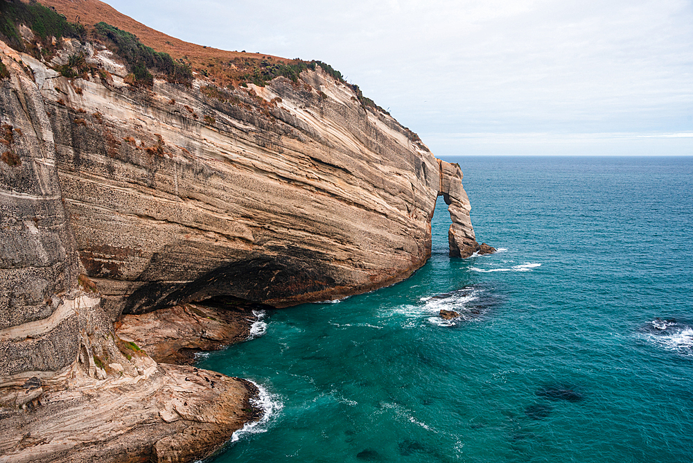 Eroded cliffs and rugged coastlines define the dramatic scenery of Cape Farewell, the northernmost point of South Island, New Zealand.