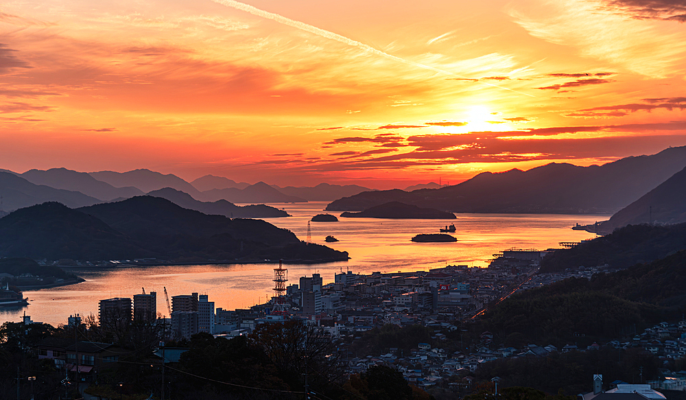 Sunset above the skyline of Onomichi with the Inland Sea of Japan, with many coves, Onomichi, Honshu, Japan, Asia