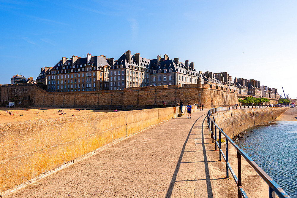 Seaside walkway along the fortified walls of Saint-Malo, Brittany, France, with panoramic views of the historic walled city
