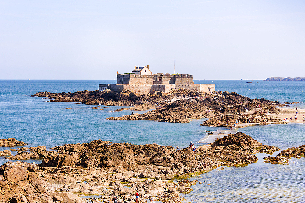 Fort National on a rocky islet off the coast of Saint-Malo, Brittany, France, surrounded by the blue waters of the Atlantic Ocean