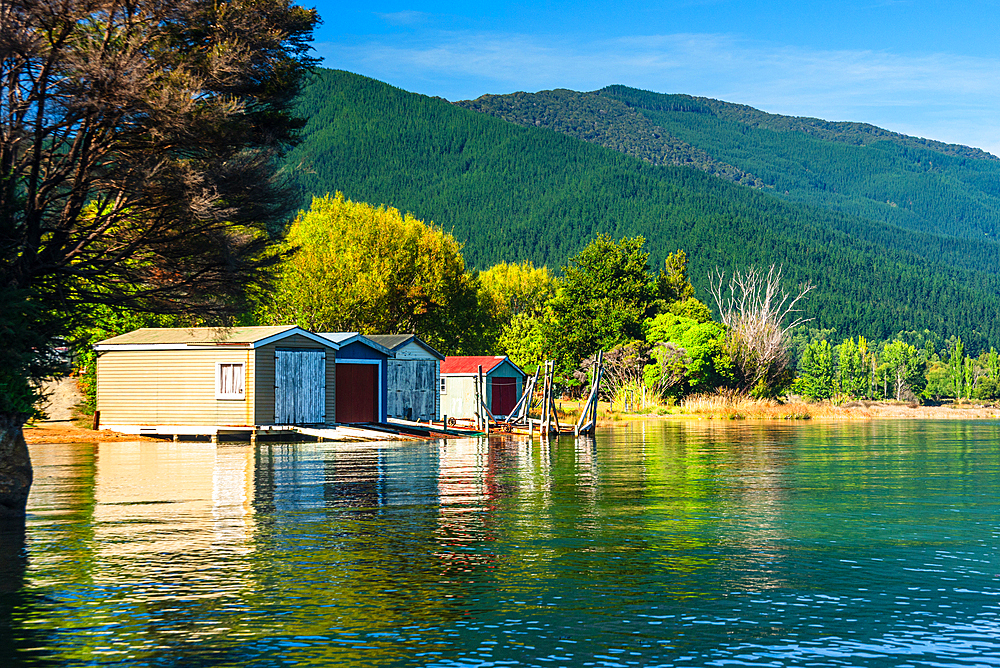 Picturesque floating boathouses line the calm waters of Marlborough Sounds near Picton, South Island, New Zealand.