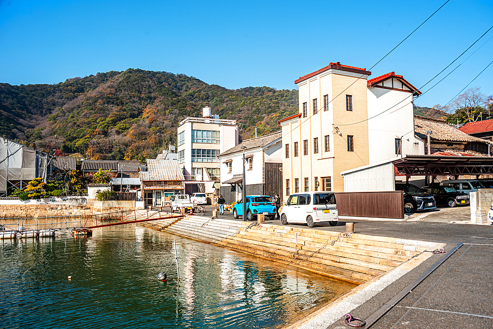 Building at the water front of Tomonoura, with a turquoise water basin in front, Tomonoura, Honshu, Japan, Asia