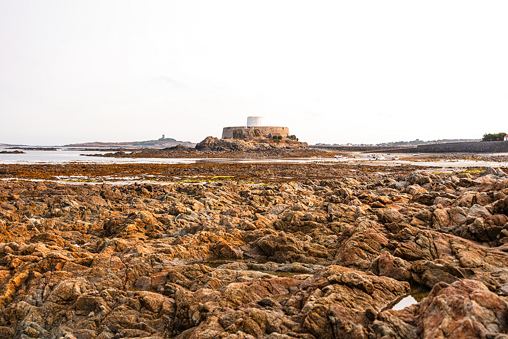 Fort Grey Martello tower on rocky tidal shore in Guernsey Channel Islands historic landmark