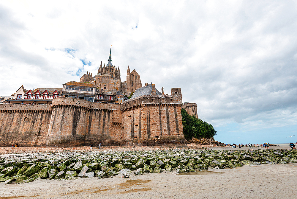A detailed view of Mont Saint-Michel’s massive stone fortifications and Gothic abbey rising above the tidal bay in Normandy, France