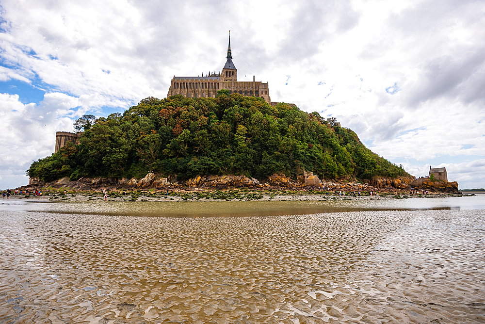 The other side of Mont Saint Michel Island and Abbey Surrounded by Tidal Waters Normandy France. Reflecting in tidal waters
