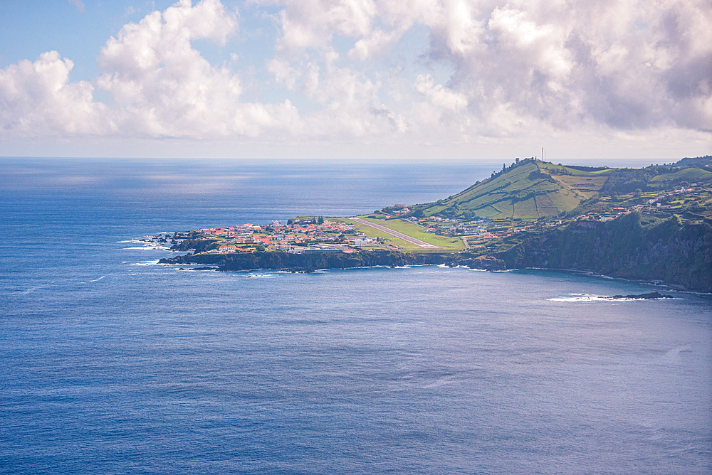 Aerial view of Santa Cruz das Flores, the island’s capital, perched on a rocky headland overlooking the Atlantic Ocean, Flores Island, Azores, Portugal.