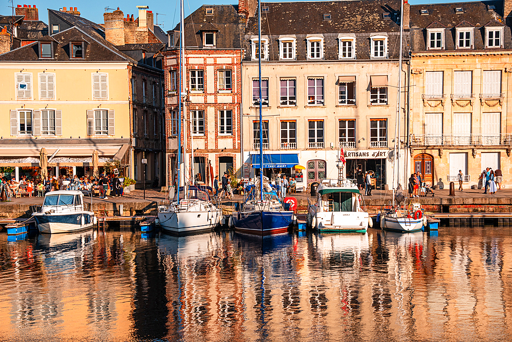 Waterfront houses and moored sailing boats at the historic Vieux Bassin harbor, Honfleur, Normandy, France.
