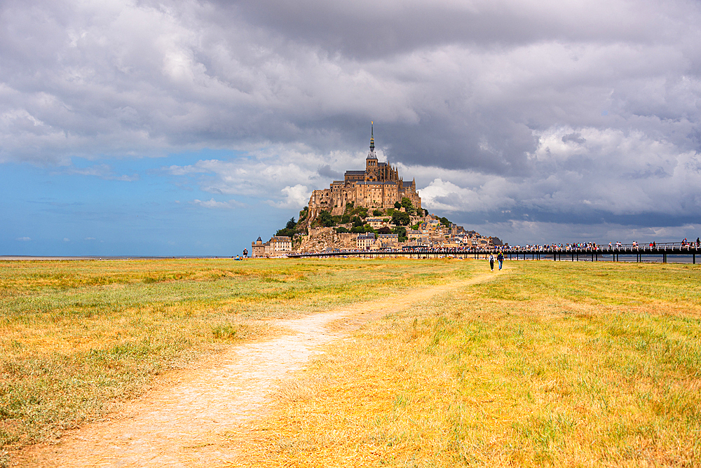 Pathway leading across grassy plains toward Mont Saint-Michel island, Normandy, France