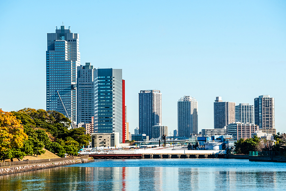 Takeshiba at Sumida River, view over the river to the skyscrapers on the blue skyline in Chuo, Tokyo, Honshu, Japan, Asia