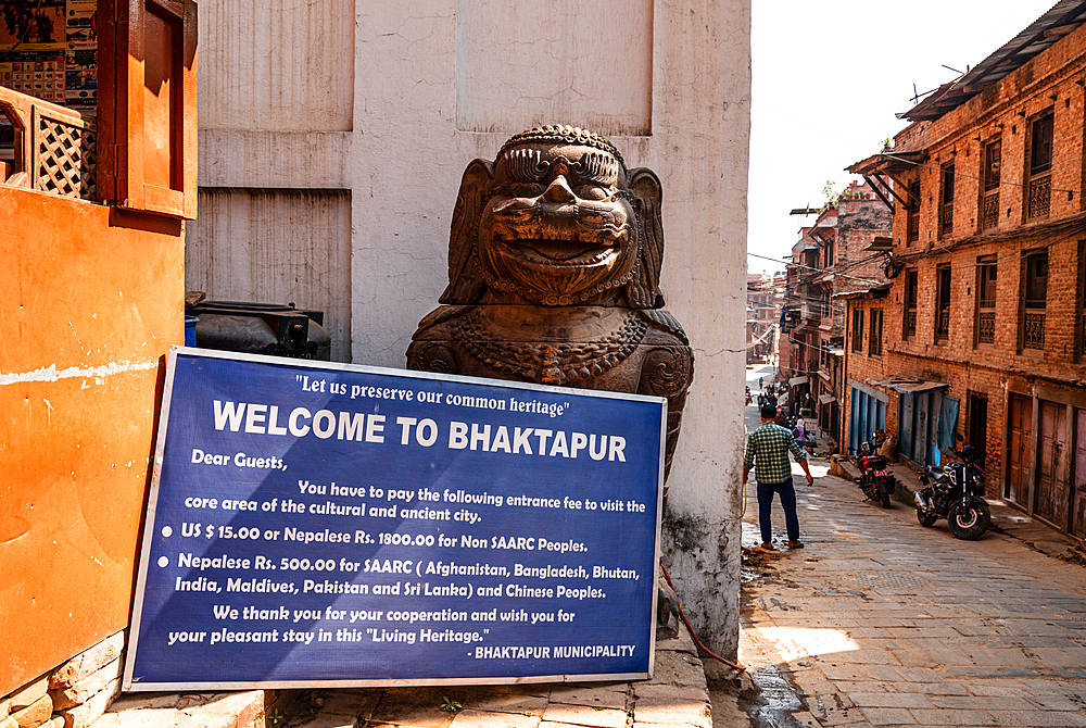 Entrance sign to Bhaktapur old town area with Lion Statue guarding the alley, Bhaktapur, Nepal, Asia