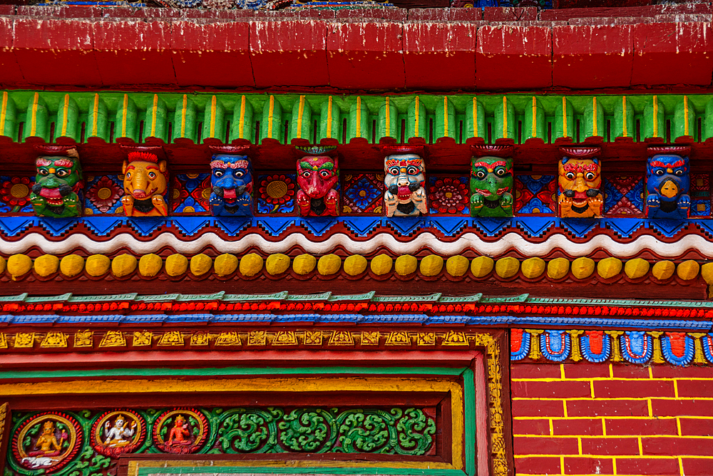 Detail of colorful wood carved faces of Changu Narayan Temple, Nepal, Asia