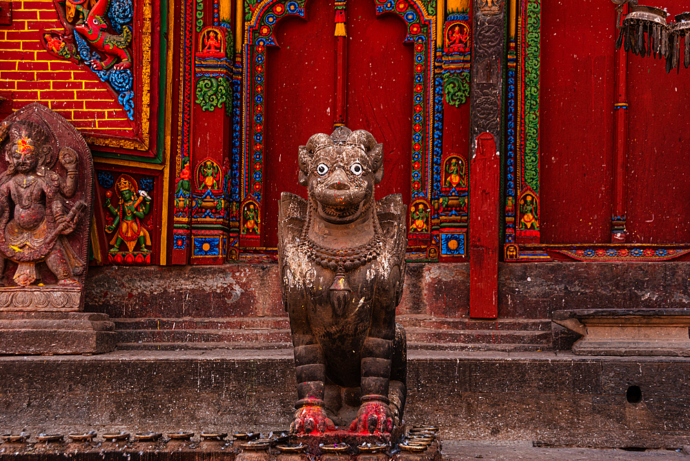 The guardian Bird statue in front of red wall at Hindu Temple of Changu Narayan, UNESCO World Heritage Site, Changunarayan, Kathmandu Valley, Nepal, Asia