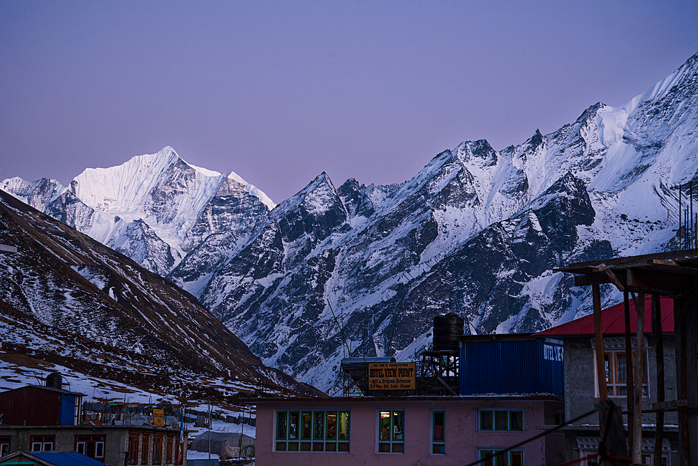 View over Kyanjin Gompa town with soft purple light after sunset and snowy summit of Gangchempo, Lang Tang Valley Trek, Himalayas, Nepal, Asia