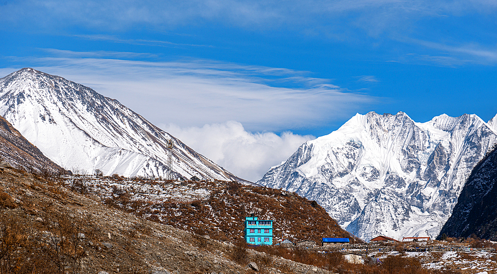 Towering ice capped mountains of Tserko Ri and Gangchempo, and beautiful turquoise mountain lodge in Langtang village, Langtang Valley, Himalayas, Nepal, Asia