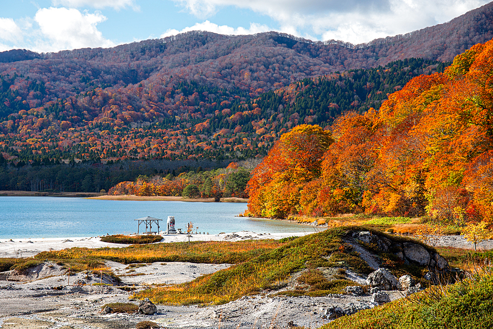 Beautiful autumn landscape of fire red leaves and soft blue volcanic lake, Lake Usori at Osorezan Bodaiji Temple, Mutsu, Aomori prefecture, Honshu, Japan, Asia