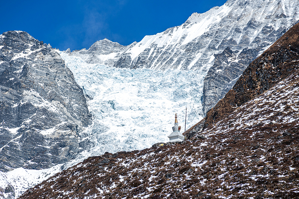 Close up of stupa (chorten) on a mountain slope in front of glaciers, Kyanjin Gompa, Langtang Valley trek, Himalayas, Nepal, Asia