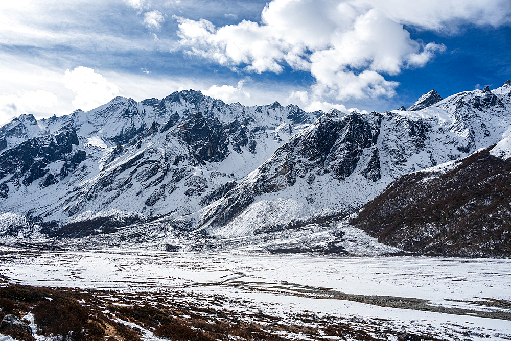 View over the snowy glacial plain of high altitude winter valley on the Langtang trek in Kyanjin Gompa, Himalayas, Nepal, Asia