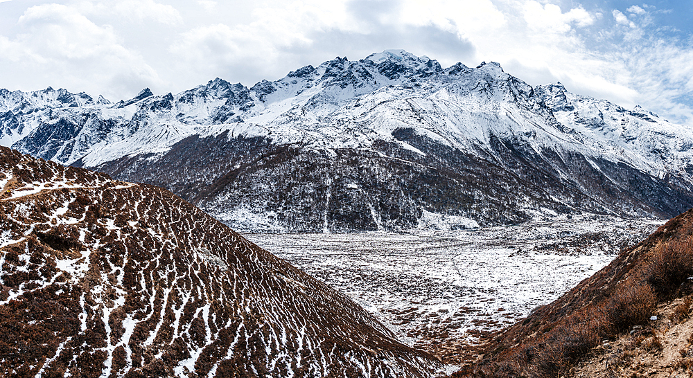 Panorama overlooking the vast high altitude mountains of Langtang Valley Trek with snow plains near Kyanjin Gompa, Himalayas of Nepal, Asia