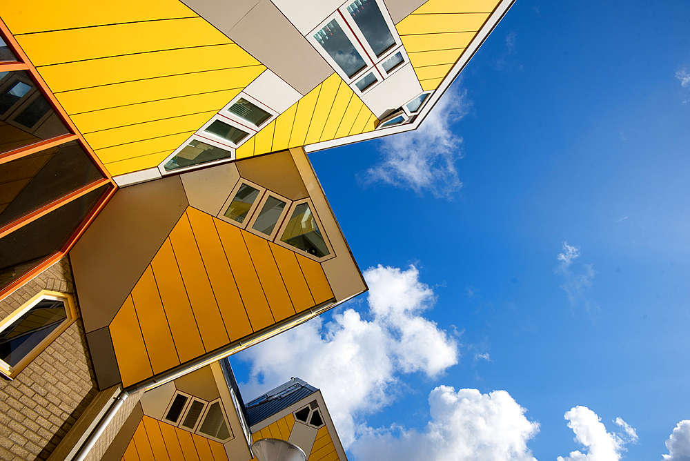 Cube Houses, vibrant yellow unique cube architecture with a blue sky, Rotterdam, The Netherlands, Europe