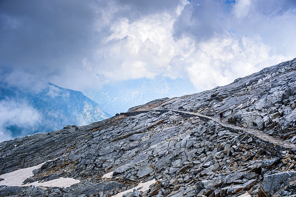 Hiking path traversing rock plains and rocky mountain top pass area of Colle del Turlo, Vercelli, Piedmont, Italian Alps, Italy, Europe