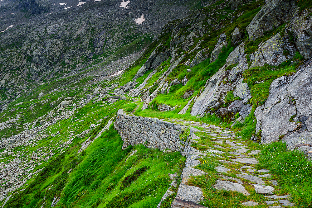 Beautiful hiking path on steep rocky and grassy slopes in the Italian Alps, Colle del Turlo, Vercelli, Piedmont, Italy, Europe