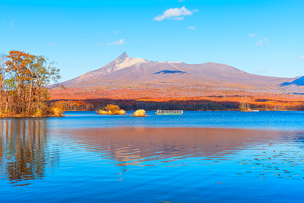 Vibrant autumn colors reflecting in Lake Onuma, with view to Hokkaido Koma-ga-take volcano, Onuma, Hokkaido, Japan, Asia