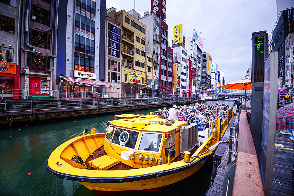 Yellow cruising boat on the Dotonbori river, Osaka,Honshu, Japan, Asia