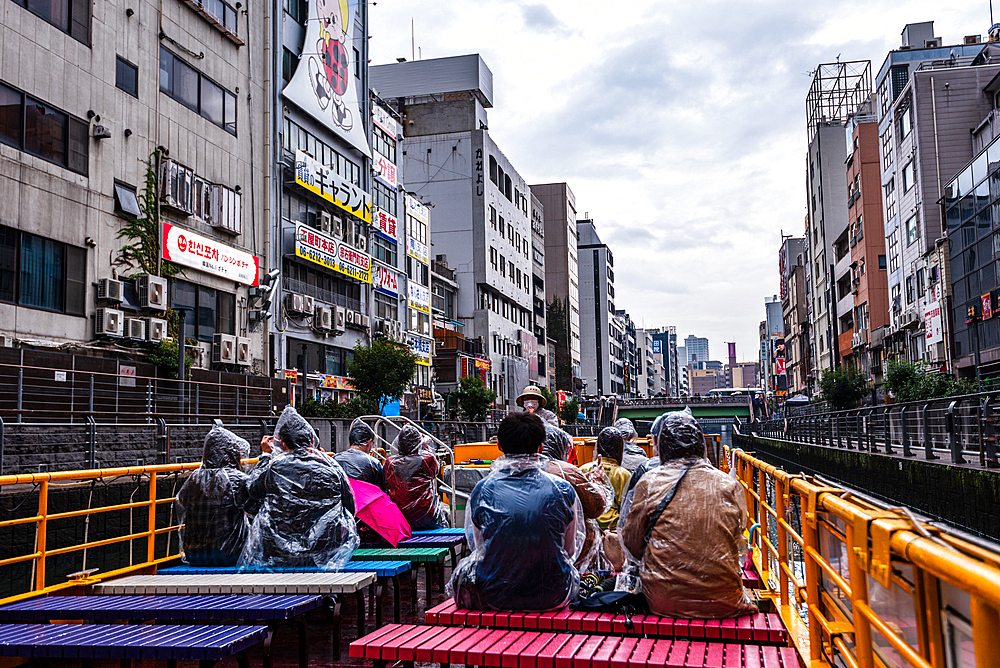 Dotonbori, River cruise on vibrant rainy day in the heart of Osaka, Honshu, Japan, Asia