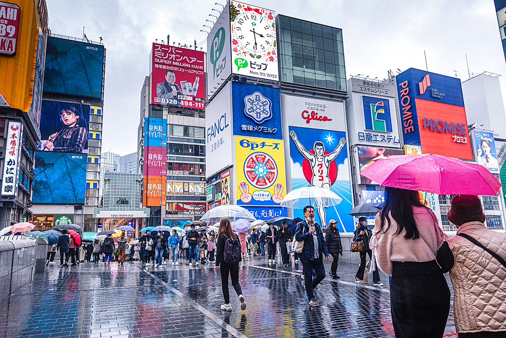 Famous Dotonbori Glico Sign. Large vibrant advertisment on a rainy day. Dotonbori, Osaka, Japan