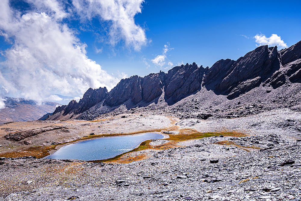 Dramatic rugged mountain range with a lake, Laguna del Rio Secco and Pico del Pulpito, Sierra Nevada, Andalusia, Spain, Europe