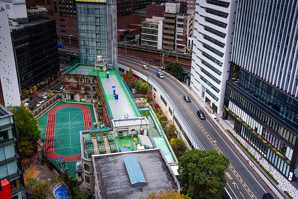 Aerial view of big Intersection in Ginza, looking over the streets, football pitch and skyscraper facades, Tokyo, Honshu, Japan, Asia