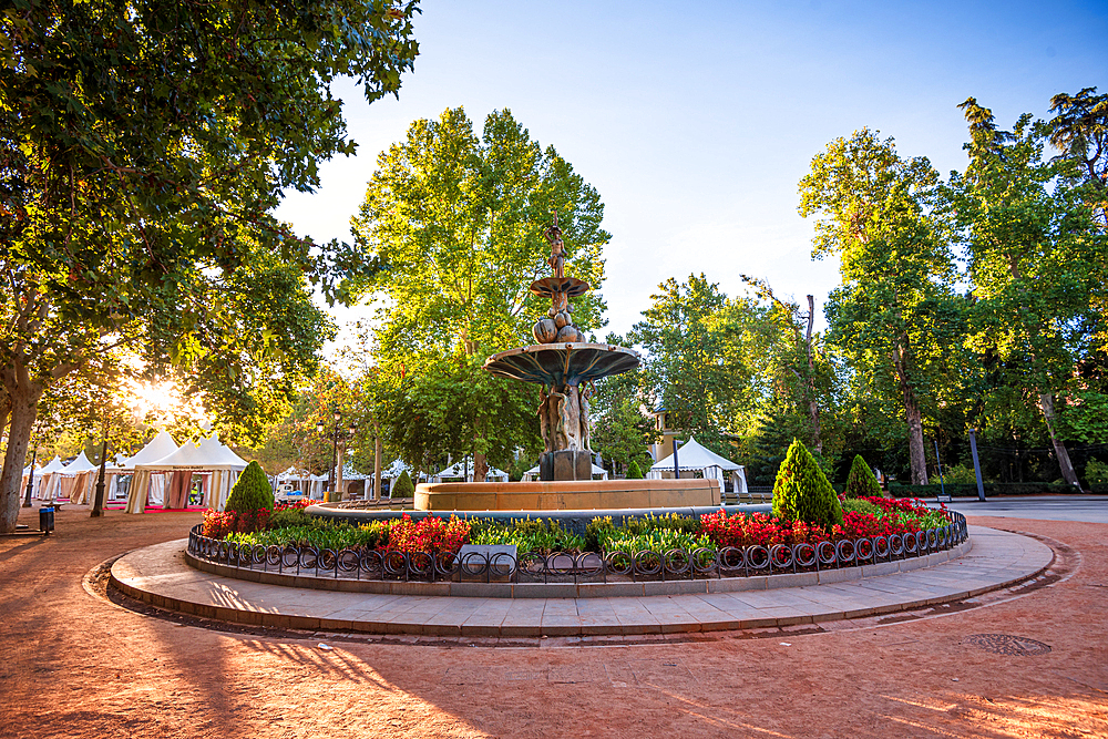 Beautiful fountain with flowers and lush green trees, Los Fuentes de Granada, Granada, Andalusia, Spain, Europe