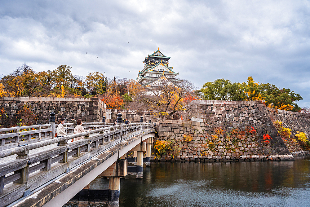 Beautiful Osaka Castle moat in autumn (fall) with bridge leading over the waters towards the Samurai Castle, Osaka, Honshu, Japan, Asia