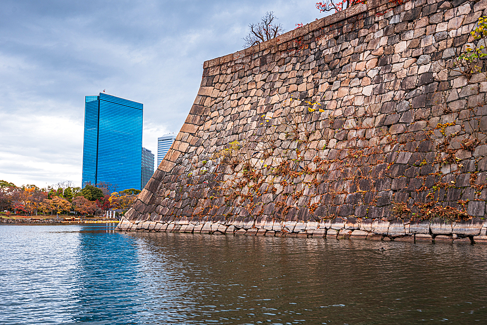 Osaka Castle walls and moat with The Crystal Tower, Osaka Business Park beyond, Osaka, Honshu, Japan, Asia